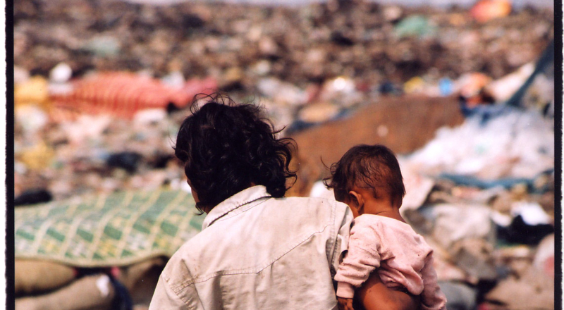 Girl & baby in dump